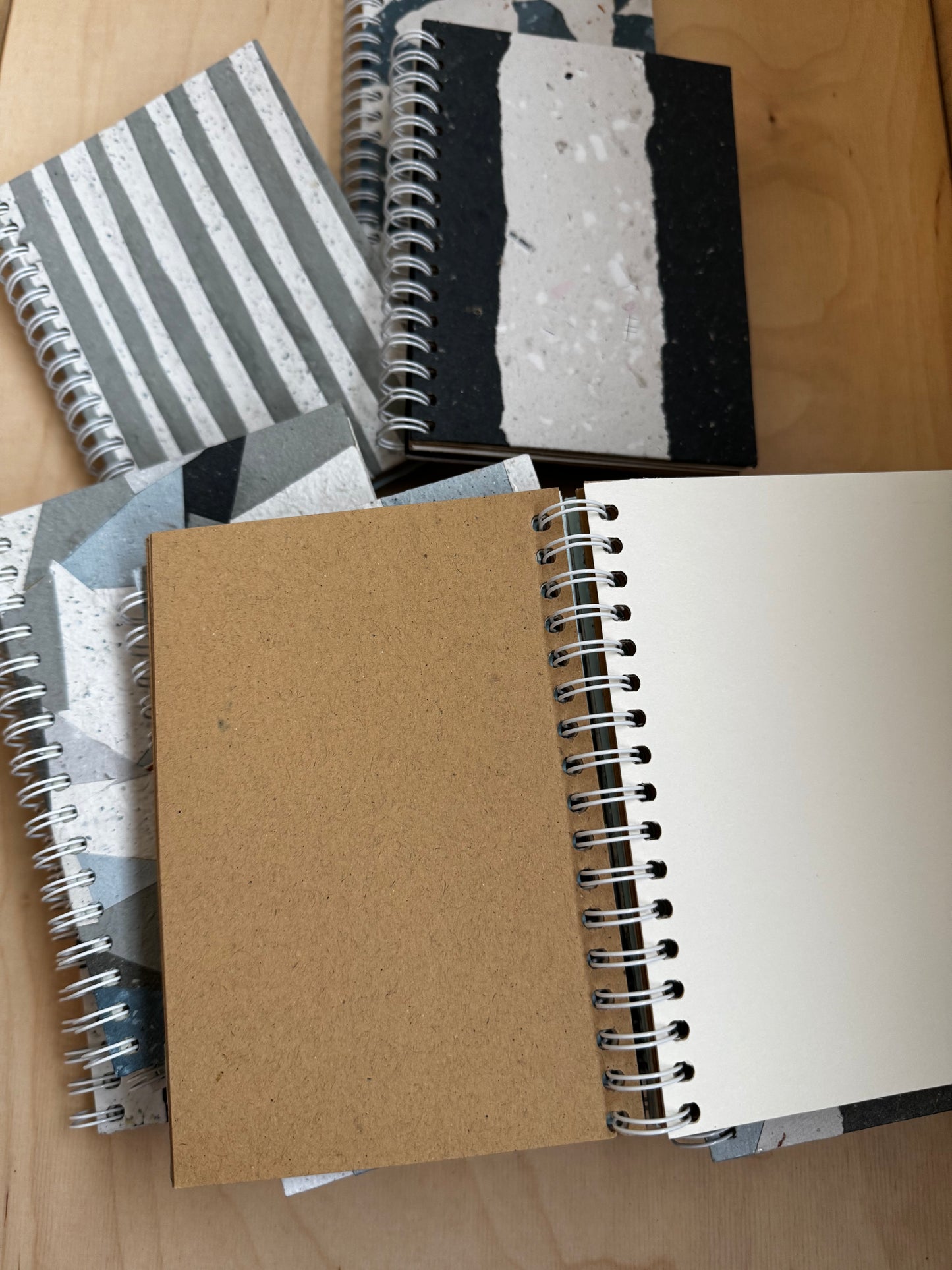Stack of environmentally responsible spiral notebooks with blank pages. Paper is mint condition.