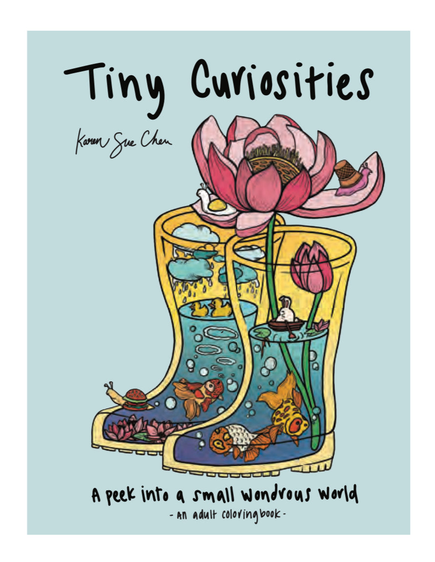 The cover of the Tiny Curiosities adult coloring book shows ponds full of beautiful fish, ducks, snails and lotus flower plants inside a pair of yellow rain boots. The subtitle is âA peek into a small wondrous worldâ.